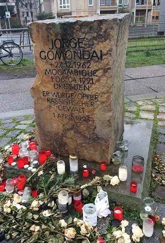 Jorge Gomodai memorial stone with flowers and candles