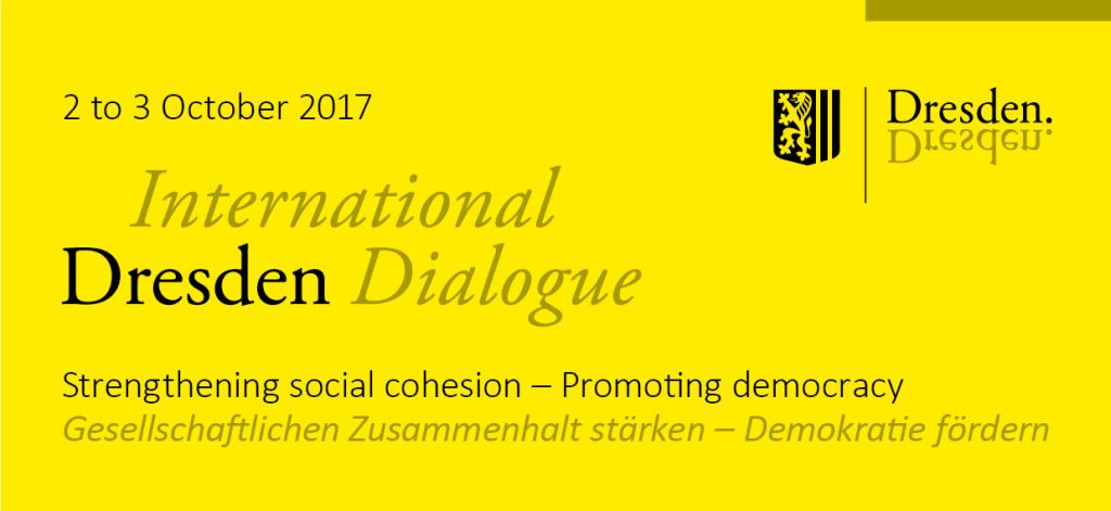 Logo in gelber Farbe mit dem Text "Internationaler Dresden Dialog" -Gesellschaftlichen Zusammenhalt stärken - Demeokratie fördern