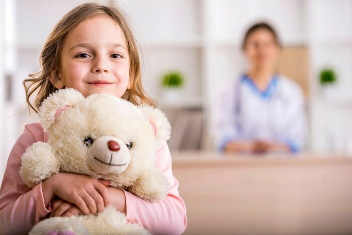 Girl with teddy in a hospital