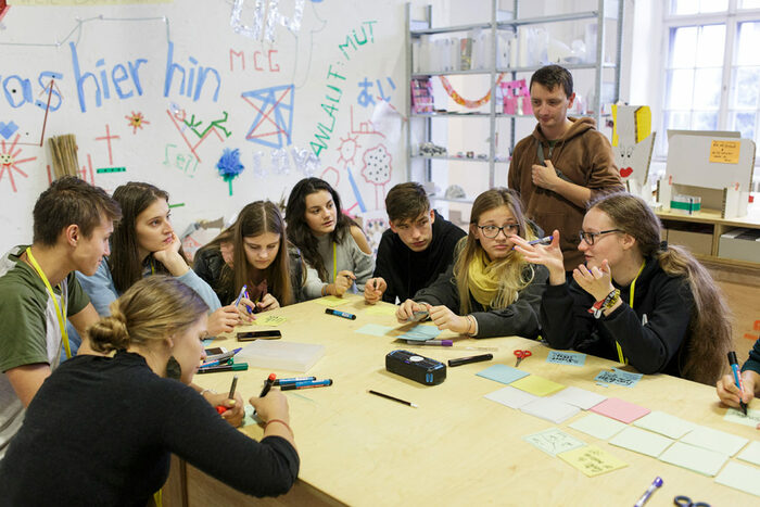 Students around a table debate how to shape urban space