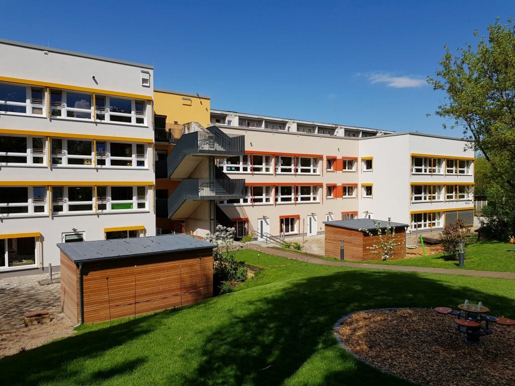 Außenansicht der sanierten Kita Dahlienweg 23-25 mit Garten/Spielplatz