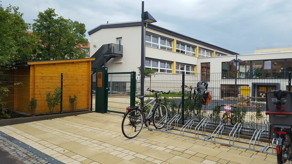 Blick auf das Tor vor dem Haupteingang mit Fahrradständern
