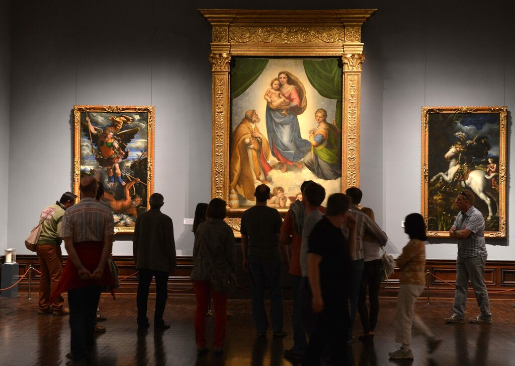 Visitors in front of the Famous Painting "Sistine Madonna"