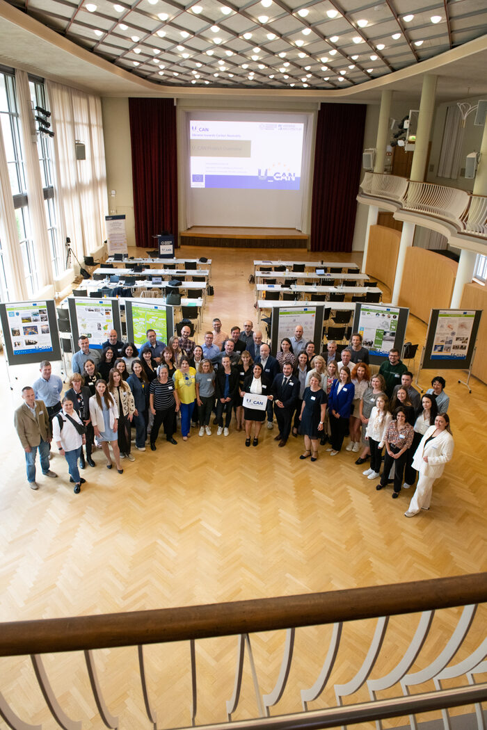 Menschengruppe steht vor Präsentationswänden