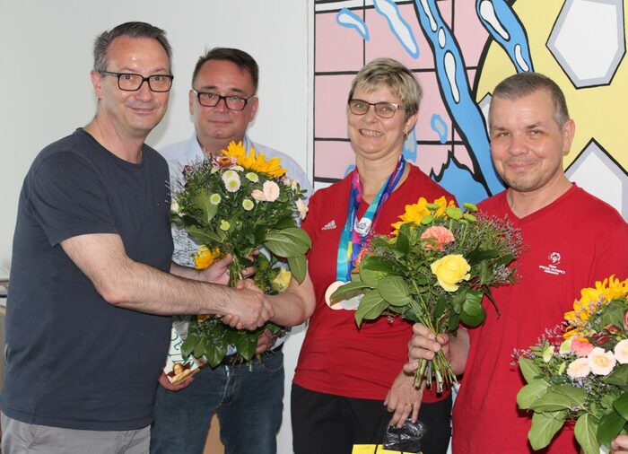 Bürgermeister Jan Donhauser gratuliert den Special Olympics-Medaillengewinnern Dörte Leistikow, Frank Schürmann und dem Trainer Jens Schön