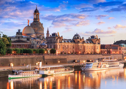 Famous Dresden city scenery with Frauenkirche, Brühlscher Terrasse and the steam ships on the Elbe at sunset.